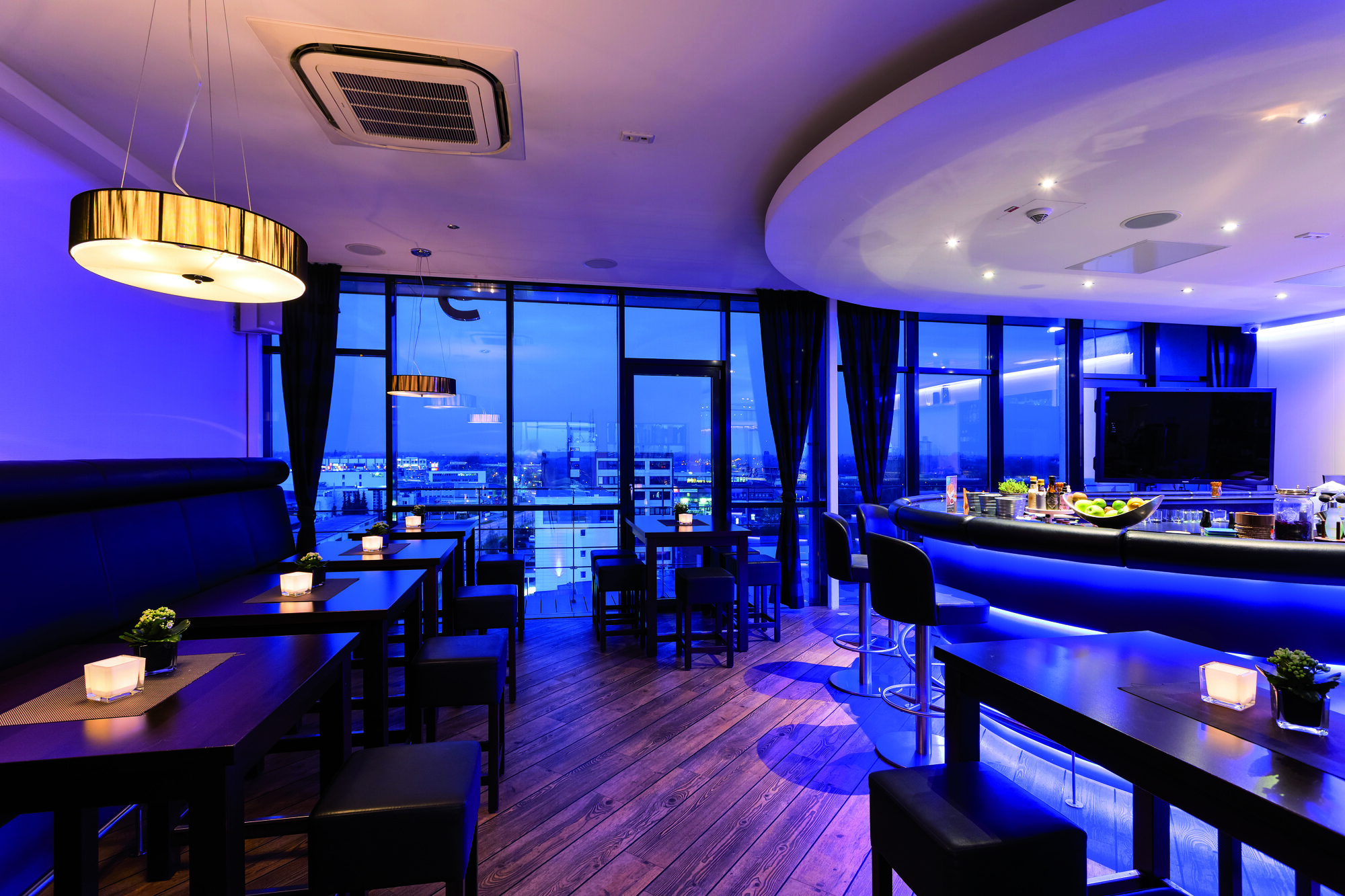 Longhorn rooftop bar interior with blue ambient lighting