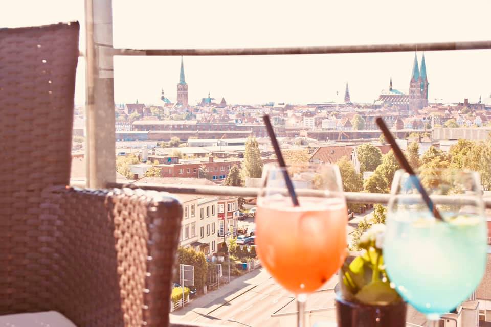Colorful cocktails with panoramic city view from rooftop