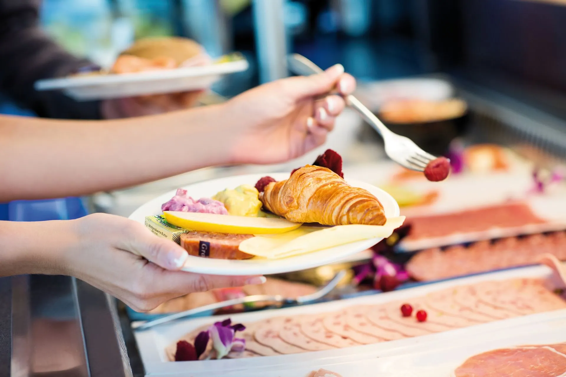 Delicious breakfast plate with croissant and fresh fruit